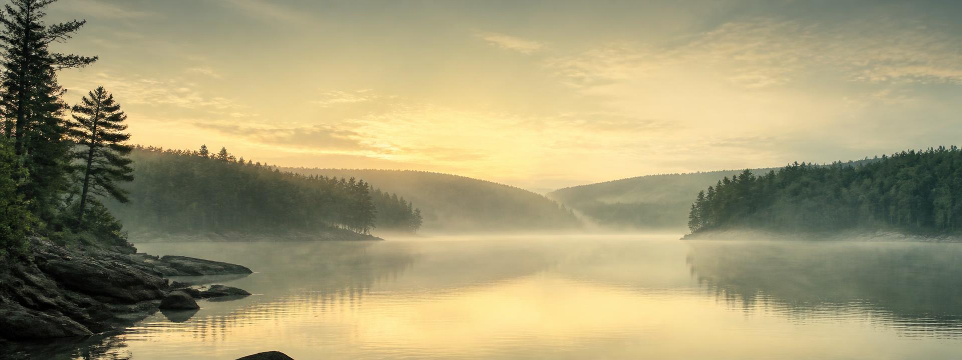 Mist over a lake at sunrise in the Ouachita Mountains of Arkansas